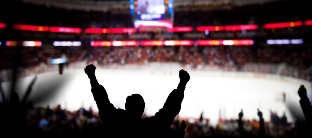 Fan cheering at hockey game arena